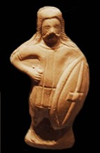 A statuette of a barbarian soldier carrying a Celtic shield