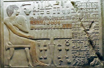 Bas relief Egyptian depicting a seated male figure