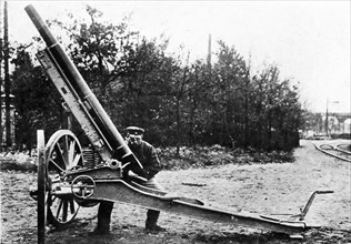A German 21-centimeter siege mortar with caterpillar wheels