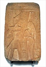 Queen Karoma and King Osorkon of Egypt standing before a god