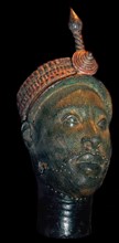 Brass head with a beaded crown and plume