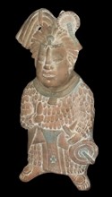 Mayan priest holding a knife and a fan