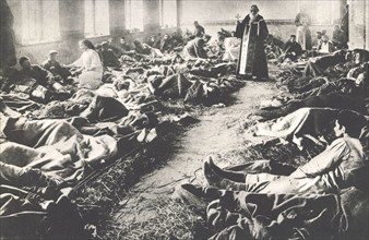 World War I: Orthodox priest in a Russian military hospital ward.