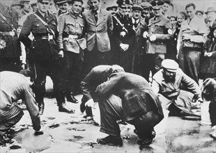 Austrian Nazis and local residents humiliating Jews