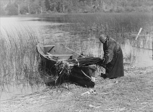 Cowichan woman putting tule