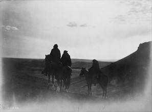 Three Navaho Indians on horseback