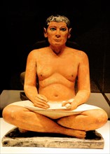 Scribe sitting cross-legged with a papyrus in his lap 2350 B