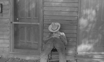 Ex-farmer resting by a house in Circleville,1938
