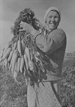 Marusya Sukhova with carrots grown on a collective farm in USSR
