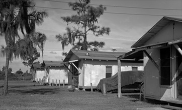 Housing in a tourist camp occupied by migrant citrus workers. Many migrants, who cannot afford to rent such houses, live in tents or in crude homemade trailers. Winterhaven, Florida 19370101