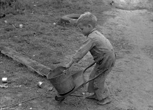 Child of white migrant worker playing with automobile tools near Harlingen, Texas By Russell Lee, 1903-1986, photographer Date 19390101.