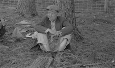 Migrant worker resting along roadside, Hancock County, Mississippi By Russell Lee, 1903-1986, photographer Date 19380101.