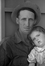 Migrant worker and his child at the Agua Fria Migratory Labour Camp, Arizona By Russell Lee, 1903-1986, photographer Date 19400101.