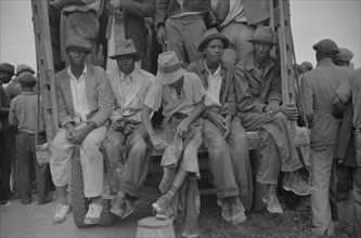 Vegetable workers, migrants, waiting after work to be paid. Near Homestead, Florida