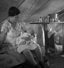 Young migrant mother with six weeks old baby born in a hospital with aid of Farm Security Administration (FSA) medical and association for migratory workers. 19390101