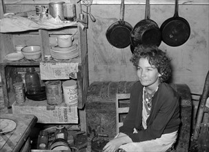 Daughter of former white labour contractor, now migrant worker, in tent home. Weslaco, Texas 19390101