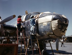 Colour photograph of a Second World War, North American B-25 bomber being prepped for painting