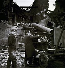 Photograph of two men loading their possessions after the Battersea Bombing Incident