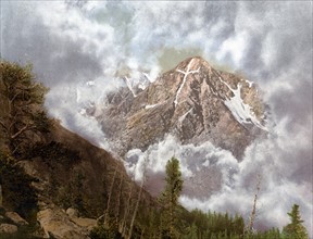 Colour photograph of the Mount of the Holy Cross in the clouds