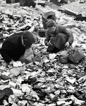 Photograph depicting a starving Berliners searching for food in a garbage dump during World War Two