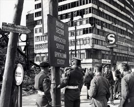Photograph of British military police erecting a sign to mark division of the British and Russian sectors of Berlin