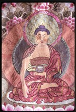Photograph of a religious silk textile (thangka) depicting Buddha