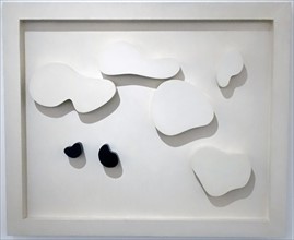 Constellation of five white shapes and two black shapes; 1932 Painted wood. By Jean Arp