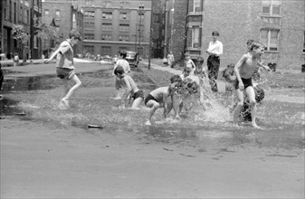 Untitled. Cooling off in water from hydrant, Chicago, Illinois July 1941.