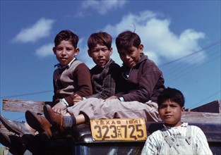 Boys sitting on a truck parked in Robstown, Texas, USA.