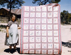 Mrs. Bill Stagg with state quilt, USA. Photographer Russell Lee.