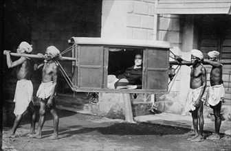 Rich English merchant carried in a palanquin, India. 1922.