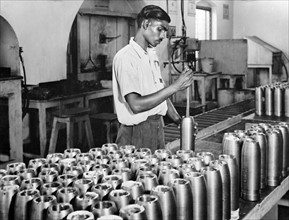 India in the war. A worker in one of India's fast expanding munitions plants.