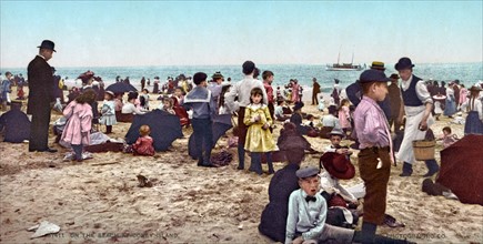 Photograph of people on the beach at Coney Island