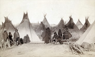 Photographic print of a group of Miniconjou peoples in a tepee camp