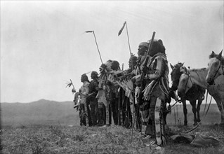 Photographic print depicting Atsina men awaiting the return of the scouts