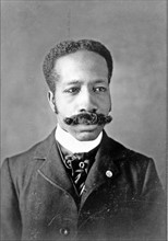 African American man, head-and-shoulders portrait, facing front.