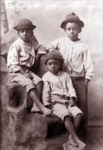 Three African American boys, full-length portrait, facing front.