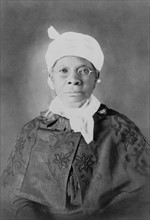 African American woman, half-length portrait, facing front.