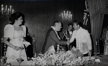 President Ferdinand Marcos greets New Zealand leader Robert Muldoon as the First Lady Imelda Marcos watches.