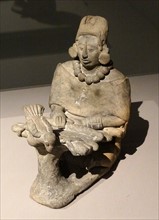 ceramic figure of an older female, depicted in a Mayan statuette