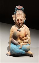 Mayan ceramic figurine of a noblewoman with a small child,