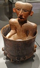 Mayan ceramic tripod vase with seated figure inside;