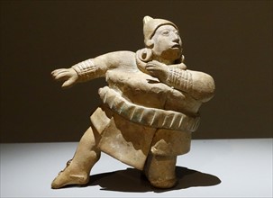 Mayan ceramic figure playing with a ball,