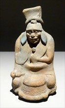Mayan ceramic figurine of an old man playing a tambourine.