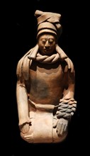 Mayan ceramic figurine of a kneeling female shaman or priestess.