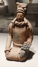 Mayan ceramic figurine of a kneeling female shaman or priestess.