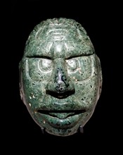 Face of the Maya Sun God carved in a green stone,