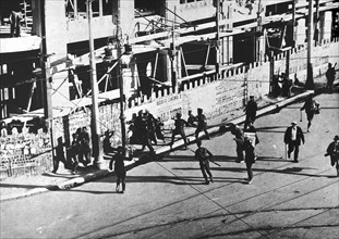 Soldiers attack a group of revolutionary strikers in Madrid.
