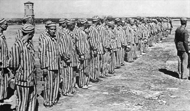 Prisoners in uniform, inside a Civil prison camp