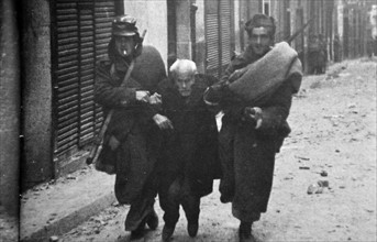 A civilian is helped to safety at Teruel, during the Spanish Civil War.